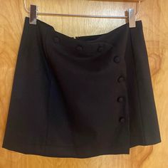 Junior Womens Short Skirt. Front And Side Buttons (Functional Buttons). Brand New. Never Worn Chic High Waist Skirt By Urban Outfitters, Chic High-waist Skirt From Urban Outfitters, Black Relaxed Fit Mini Skirt, Black Relaxed Mini Skirt, Urban Outfitters Lined Skirt Bottoms, Urban Outfitters Mini Skort With Lined Skirt, Chic Mini Skort By Urban Outfitters, Chic Mini Length Skort By Urban Outfitters, Urban Outfitters Short Lined Skirt