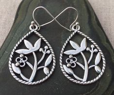 "These are pretty, highly detailed everyday silver tear drop earrings with a lovely flower motif design.  They are unique and versatile.  Perfect for everyday wear. They measure 1 1/4\" long by 7/8\" across and are made from allergy free Plated silver.  They hang from simple silver ear wire hooks. I have a matching necklace in my Etsy shop, if you would like the whole set.  Here is the link https://etsy.me/2VOaqsb  Thanks for stopping by!  Please take a moment and visit the rest of my Etsy shop. Silver Teardrop Flower Earrings For Pierced Ears, Silver Teardrop Flower Earrings, Hypoallergenic Silver Teardrop Flower Earrings, Flower Motif Design, Drop Earrings Silver, Dangle Earrings Boho, Silver Flower Earrings, Teardrop Dangle Earrings, Earrings Flower