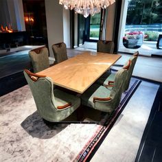 a dining room table with chairs and a chandelier