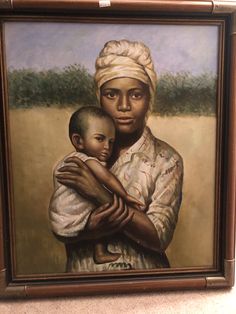 an oil painting of a woman holding a baby in her arms and wearing a turban