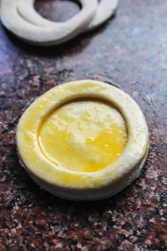 a yellow substance is sitting on the counter next to some other items that have been made out of clay