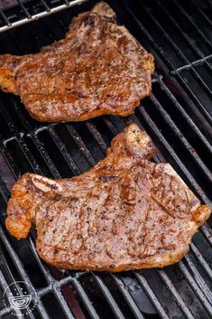 two steaks are cooking on the grill