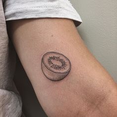 a small kiwi tattoo on the arm