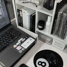 an open laptop computer sitting on top of a white desk next to a black mouse