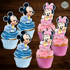 mickey mouse cupcakes with pink frosting and blue icing on wooden table