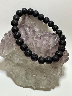 Lava Stone Bracelet: Perfect for using essential oils to diffuse the healing properties of the oil. This black lava stone has always aided in grounding one's energy, adding the essential oils will enhance the grounding and healing.  Bracelet care: Please remove your bracelets if you are going to shower and have your hands submersed in water for any length of time. Wipe them down with a soft dry cloth every so often to bring back their natural shine. Try not to wear them to bed every night as thi Adjustable Black Holistic Bracelets, Black Holistic Beaded Bracelets With Natural Stones, Holistic Black Beaded Bracelet With Natural Stones, Casual Black Jewelry For Healing, Black Holistic Round Beaded Bracelets, Holistic Black Round Beaded Bracelets, Hypoallergenic Black Beaded Bracelets For Healing, Holistic Black Bracelets With Round Beads, Minimalist Black Bracelet For Meditation