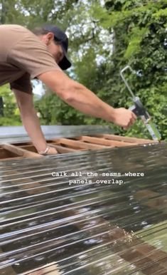 a man working on the roof of a house