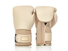 a pair of white boxing gloves sitting on top of each other