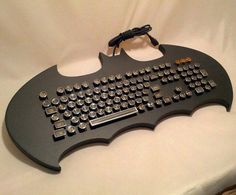 a batman keyboard is sitting on a white surface