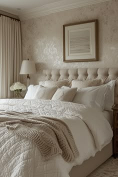 a large bed sitting in a bedroom next to a window with curtains on both sides