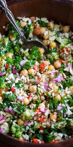 a pot filled with lots of food and a spoon in it's side dish