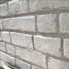 a close up of a brick wall with no mortar