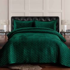 a bed with green bedspread and pillows