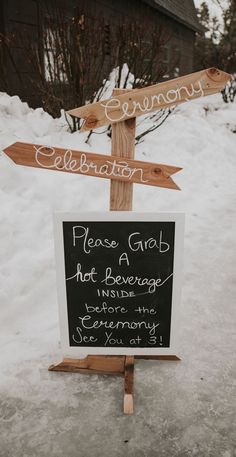 a sign that is in the snow with some writing on it and two arrows pointing to different locations