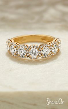 a gold ring with three rows of diamonds on it