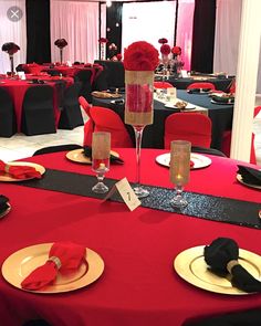 a red table topped with plates and glasses