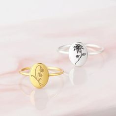 two rings with palm trees on them sitting on a white countertop next to each other