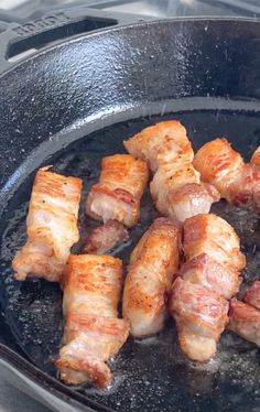 bacon wrapped chicken cooking in a skillet