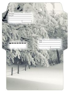 an envelope with snow covered trees in the background