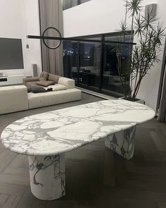 a large white marble table in a living room