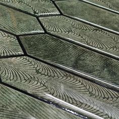 close up view of green wood with wavy lines on the top and bottom, as seen from above