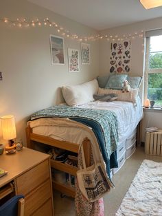 a bed room with a neatly made bed next to a window