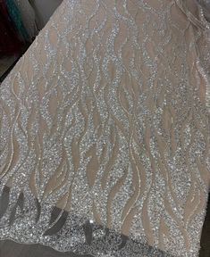 the fabric is shiny and has silver sequins on it