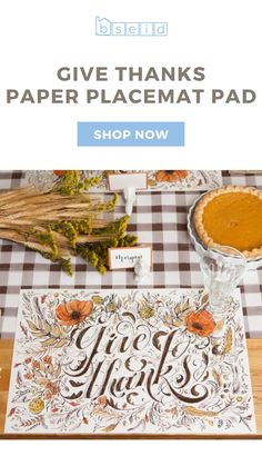 the give thanks paper placemat pad is shown on a table with pumpkins and leaves