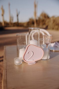 a table topped with glasses filled with liquid