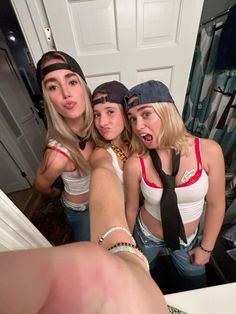 three young women are taking a selfie in the mirror