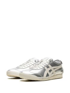 "Find ONITSUKA TIGER Mexico 66™ Sd \"\"pure Cream\"\" Sneakers on Editorialist. silver-tone off-white calf leather metallic effect signature Tiger stripes round toe front lace-up fastening logo patch at the tongue branded insole branded heel counter flat rubber sole These styles are supplied by a premium and authenticated sneaker marketplace. Stocking only the most sought-after footwear, they source and curate some of the most hard to find sneakers from around the world." Silver Sneakers With Metallic Logo For Streetwear, Sporty Silver Sneakers With Contrast Sole, Metallic Leather Sneakers For Streetwear, Silver Leather Sneakers With Contrast Sole, Sporty Metallic Silver Leather Sneakers, Metallic Sneakers With Rubber Sole For Streetwear, Silver Sneakers With Rubber Sole For Streetwear, Modern Silver Sneakers With Rubber Sole, Silver Casual Sneakers With Metallic Logo