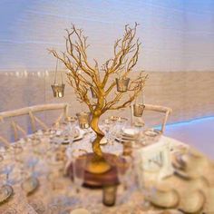 a table set up with plates and silverware for an elegant dinner or reception at the beach