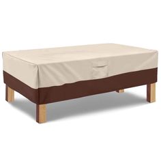 a bed with a cover on top of it and two wooden legs in front of it