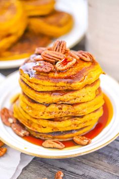 stack of pumpkin pancakes with pecans on top