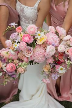 the bridesmaids are holding their bouquets with pink and yellow flowers in them