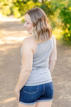 Elevate your style with the Tara Ribbed Tank in sophisticated grey! This tank combines fun and fashion with its micro ribbed texture and high neckline. Perfect for any occasion, it offers a comfortable fit that you'll love. Fabric Composition: 93% rayon, 7% spandex for a soft and stretchy feel.Fit: True to size.Model Sizing: Catherine and Tiffanee are wearing a small, and Lexi is in a 1XL. Upgrade your wardrobe with the Tara Ribbed Tank, a must-have versatile piece. Bath And Body Shop, Fall Graphic, Kimono Duster, Kids Graphic Tees, Leggings Kids, Winter Kids, Ribbed Texture, Jumpsuit Shorts Rompers, Ribbed Tank