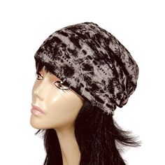 a mannequin head wearing a black and white tie dye turban hat