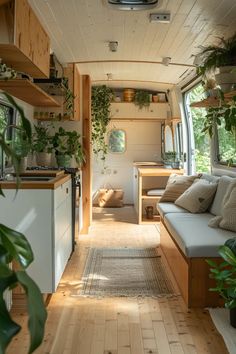 the interior of a tiny home with wood flooring and plants on the windowsill