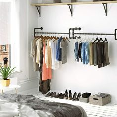 a bedroom with clothes and shoes hanging on the rack