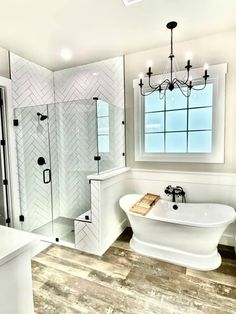 a bathroom with a tub, sink and shower