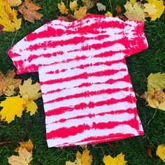 "\"Candy Cane\" Stripped Tie Dye T-Shirt This is the perfect holiday T-Shirt. Great to layer under a sweater, or blazer or by itself. It's perfect the holiday gathering, even family christmas photo's. All items are one of a kind, and made to order. There will be variations in your custom piece. T-Shirt is made of 100% cotton and are unisex sizing. These are true to size, therefore for a looser fit, I recommend sizing up. All orders are typically ready to ship out within 1-2 weeks. Check us out o Red Crew Neck Top For Holiday, Red Crew Neck Tops Casual Style, Relaxed Fit Short Sleeve T-shirt For Holiday, Red Short Sleeve Tops For Christmas, Pink Cotton Tops For Holiday, Red Cotton Holiday Shirt, Pink Cotton Top For Holiday, Fun Red Crew Neck Tops, Red Pre-shrunk Shirt For Summer