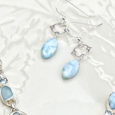 Larimar is my newest obsession, and I feel a clean look of it in a simple setting is all the grammar this gemstone needs. I have these Larimar marquee gems custom cut for me and I added them oupside this stunning filigree frame. Gems measure 15mm and earrings drape at almost 1.5”. I just love how their turned out. Wear them dolor or with any of my other Larimar pieces like this Statement Pendant Style Larimar necklace or Elegant Pendant Style Larimar Necklace Or with a classic Katie rosary in pe Elegant Handmade Larimar Jewelry, Elegant Larimar Jewelry For Formal Events, Elegant Larimar Dangle Earrings, Filigree Frame, Rosary Jewelry, Larimar Necklace, Pearl Rosary, Classic Earrings, Elegant Pendant