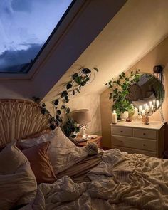 a bedroom with a bed, mirror and plants on the wall in front of it