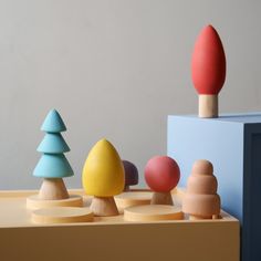 wooden toys are lined up on a table