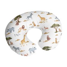 a white neck pillow with various animals and giraffes printed on the front