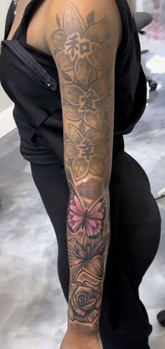 a woman with a tattoo on her arm and leg is sitting in front of a mirror