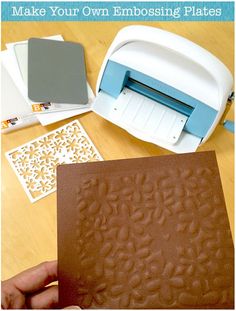 someone is using a machine to make embossing plates for their crafting project