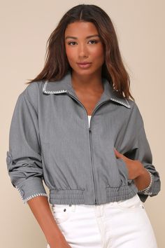 Let everyone see your on-trend aesthetic with the Lulus Cool Impulse Grey Embroidered Bomber Jacket! Lightweight woven fabric shapes this eye-catching jacket that has a collared neckline and long sleeves with button cuffs and adjustable button snaps. Zippered bodice has vertical welt pockets and a lightly cropped silhouette with an elasticized hem. White wmbroidered accents throughout lend an adorable finish. Fit: This garment fits true to size. Length: Size medium Bust: Great for any cup size. Spring Outerwear With Button Cuffs And Collar, Spring Collared Outerwear With Button Cuffs, Trendy Cropped Jacket With Lapel Collar For Spring, Trendy Collared Cropped Jacket For Spring, Trendy Spring Cropped Jacket With Lapel Collar, Embroidered Lapel Collar Outerwear For Fall, Trendy Collared Outerwear With Button Cuffs, Spring Outerwear With Snap Buttons And Lapel Collar, Trendy Cropped Jacket With Lapel Collar