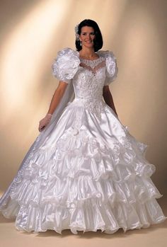 a woman in a wedding dress posing for the camera