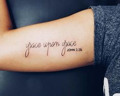 a person with a tattoo on their arm that reads grace upon grace john 11 16